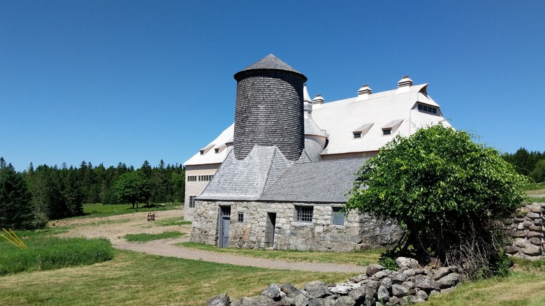 close up of Van Horne's Barn with lush trees and blue sky