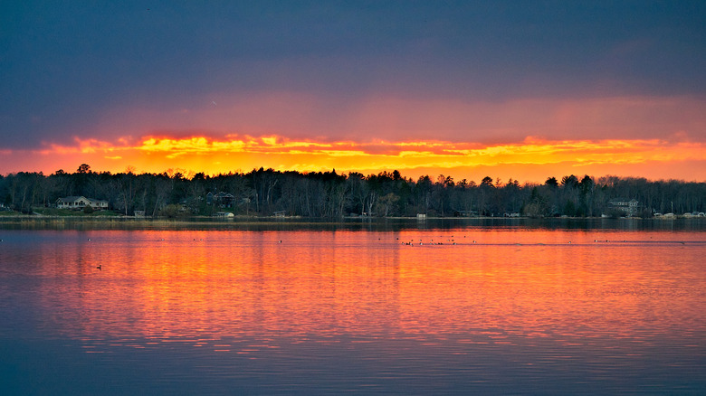 Sunset over Lake in Bemidji, Minnesota with ducks swimming