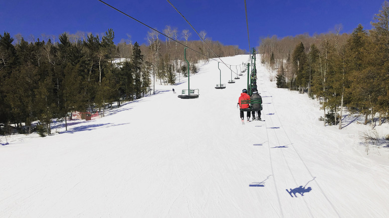 Skiers on chairlift up snowy mountain near Lutsen, MN