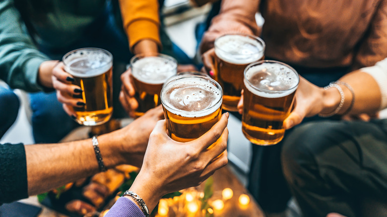 people clinking beers