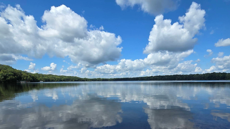 Puffy white clouds are reflected on the still waters of Little Carnelian Lake near Stillwater, Minnesota