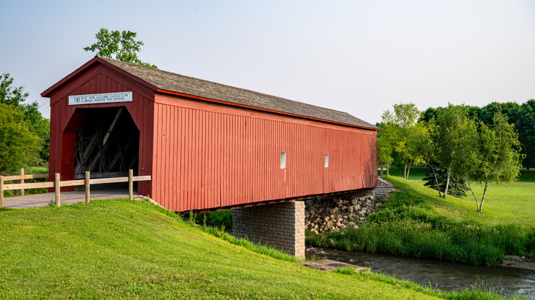 A historic red covered bridge spanning the river in Zumbrota