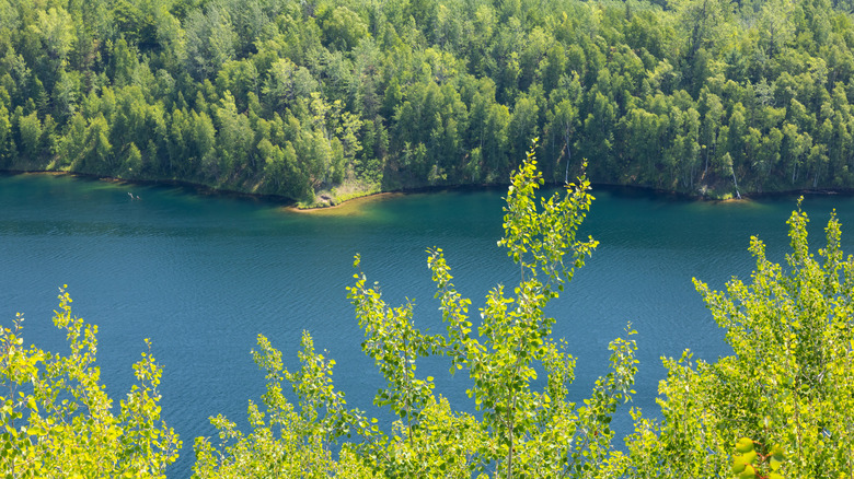 Clear deep blue water, surrounded by trees, in the Cuyuna Region, Minnesota