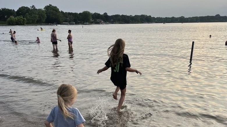 People in the water at the beach in Antlers Park in Lakeville, Minnesota