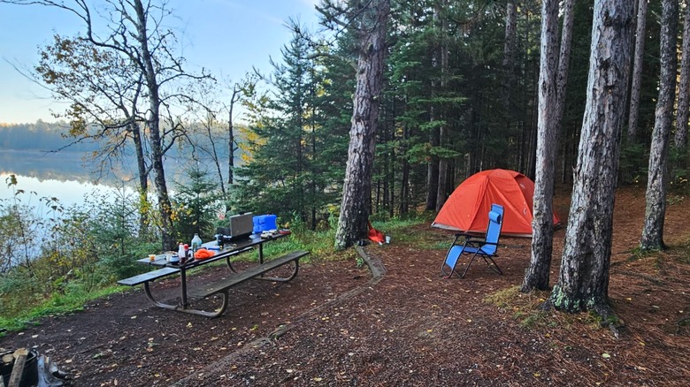 Red tent and picnic table overlooking the lake, Indian Lake Campground, Cloquet Valley State Forest in Minnesota