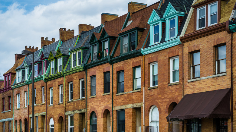 The brick and marble facades of Station North's 19th-century three-story rowhouses positioned wall to wall.