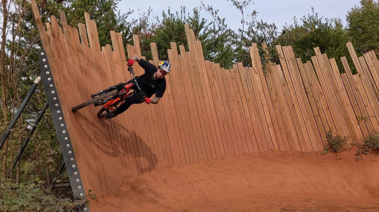 A biker riding off the wall on a difficult biking course in Baker Creek Preserve