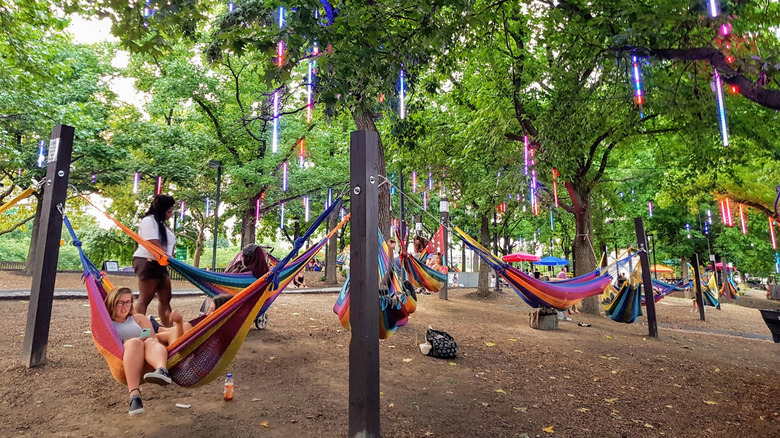 People lying in hammocks at Spruce Street Harbor Park in Philadelphia