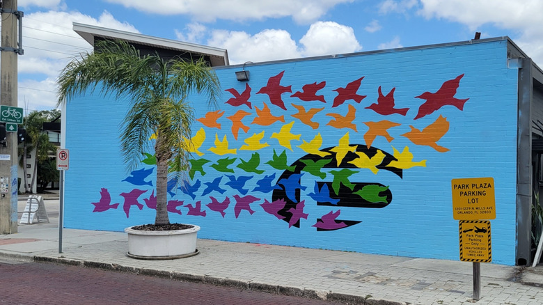 murals with doves painted on blue wall