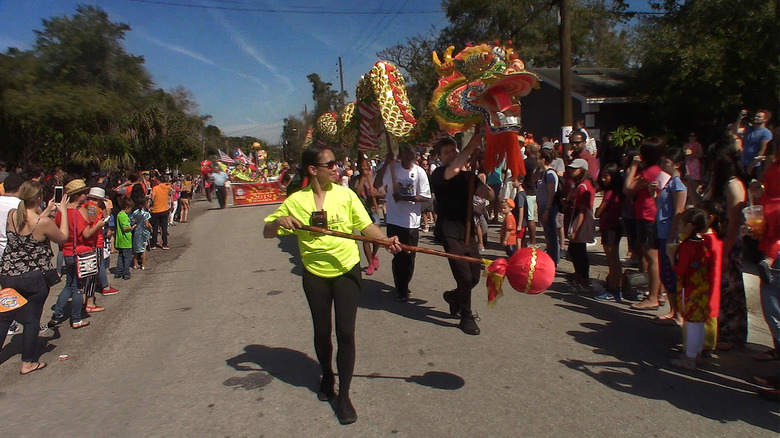 parade with people carrying a dragon