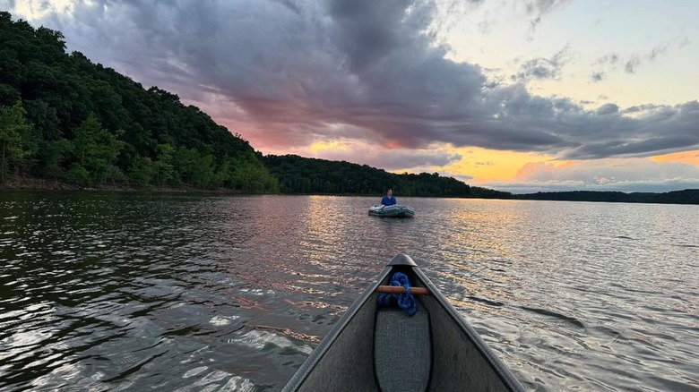 A boat and canoe on Lake Wappapello at sunset