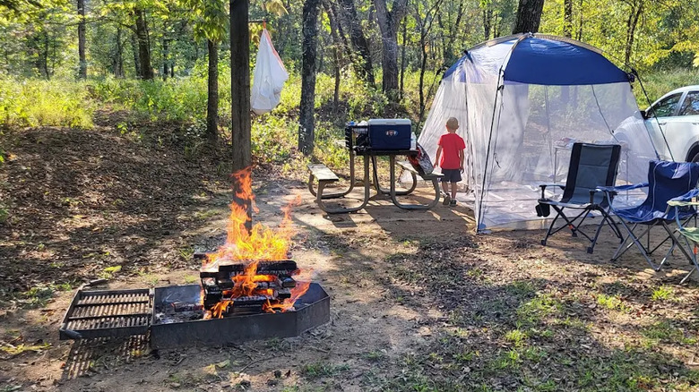 tent, chairs, other camping paraphernalia, and campfire at Sam A. Baker State Park, Missouri