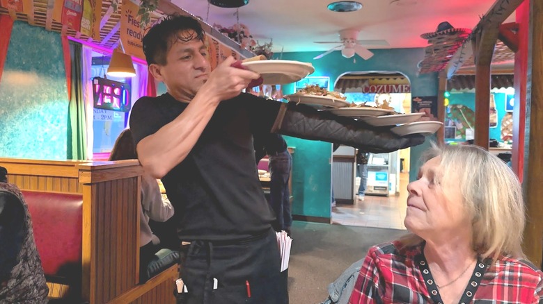 Server delivering dishes at Mexican restaurant Cozumel in Houston, Missouri
