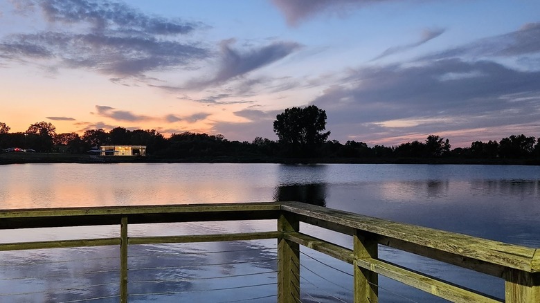 Johnston Lake with calm waters at Hawk Ridge Park during sunset in Raymore, Missouri