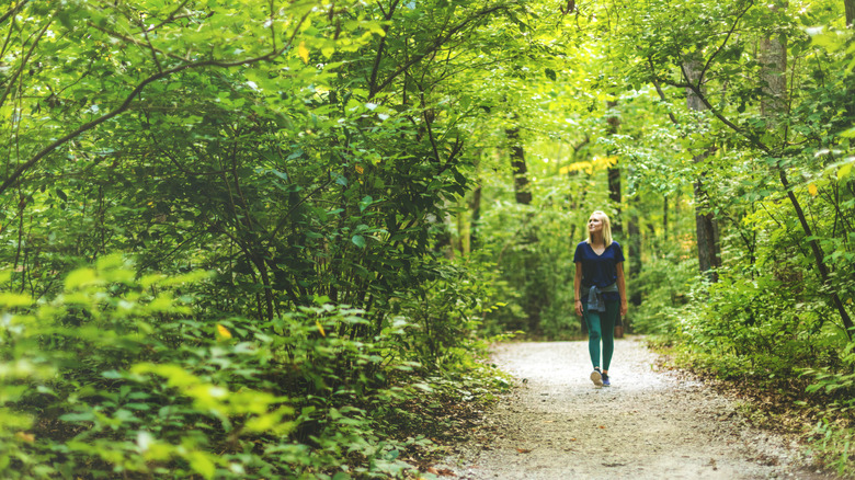 woman on forested walking trail in Missouri