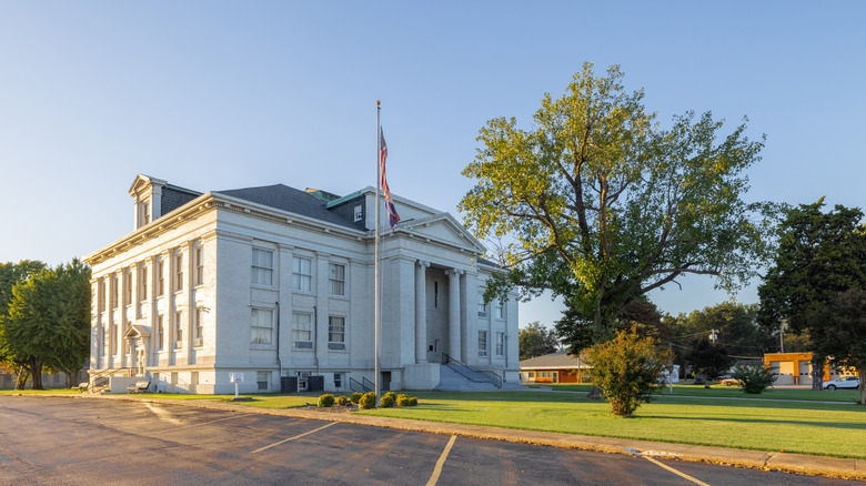 The exterior of the New Madrid Historical Museum with trees in its front lawn