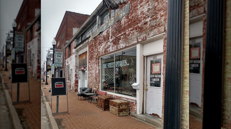 Coal Street Antiques storefront in a weathered brick building in downtown Mexico, Missouri