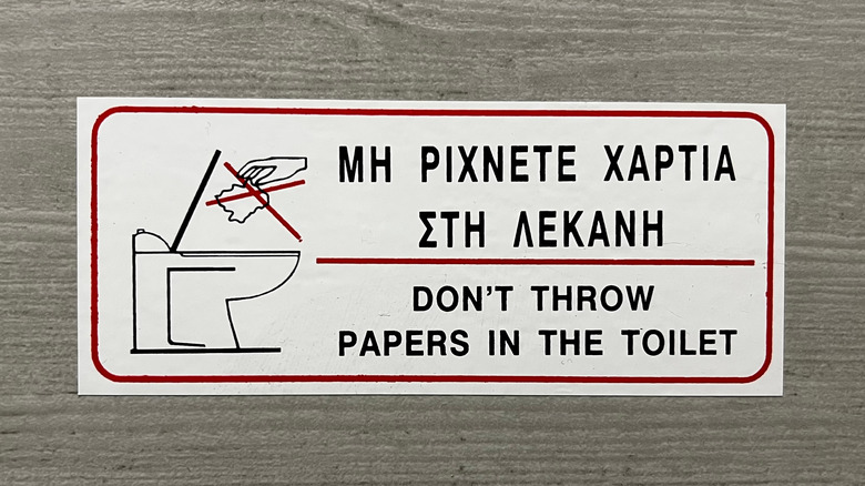 Bathroom sign in Greek and English