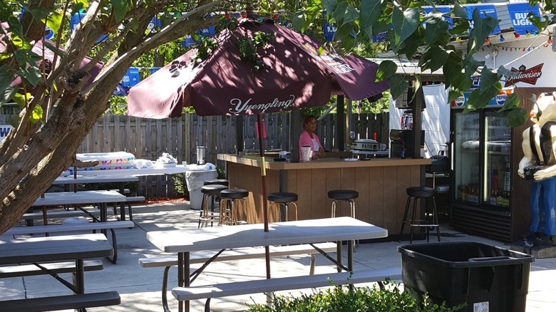 The outdoor patio of Mitiwanga's only restaurant with picnic tables, shade, and an outdoor bar