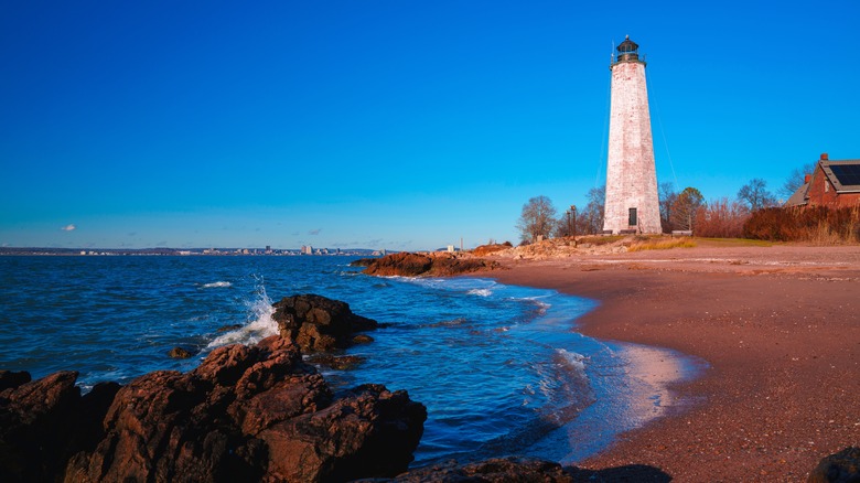A Connecticut lighthouse pictured on a beach