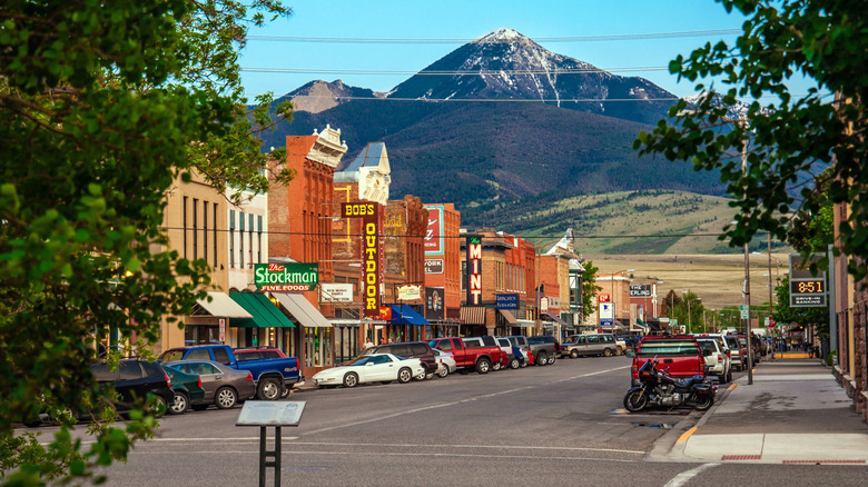 Livingston's Old West downtown with neon signs and a mountain in the background.