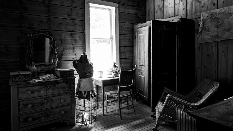 Interior image of one of the still-intact homes at Garnet Ghost Town, an abandoned mining town near Missoula, Montana, U.S.A., photographed in black and white on a bright day