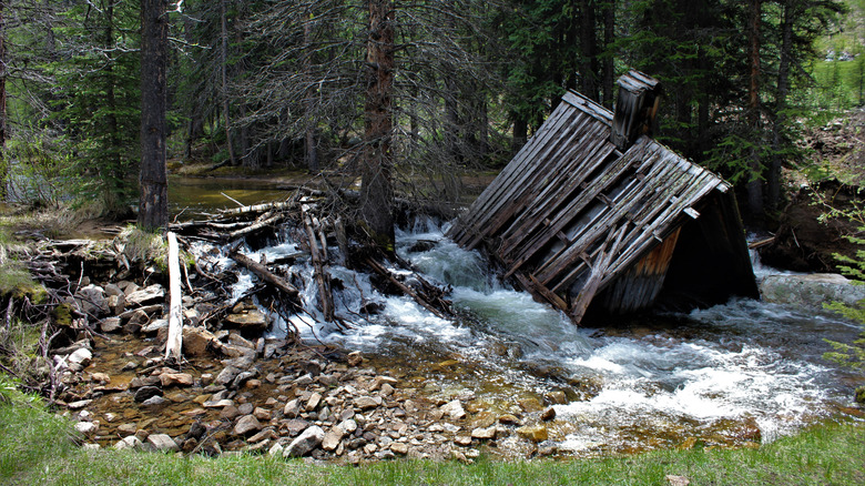 Wooden structure partially submerged in river at Coolidge, Montana