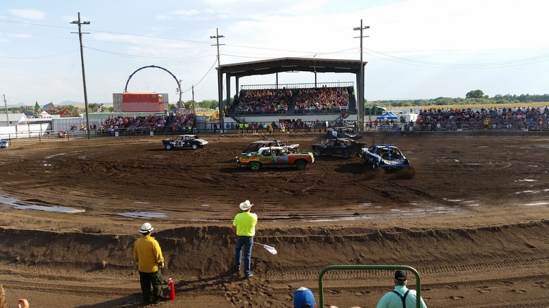Demo derby and grandstands filled with people at fair