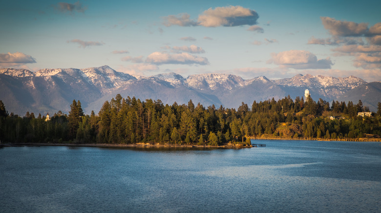 Eastern shore of Flathead Lake in Montana with snow-covered mountains in the background