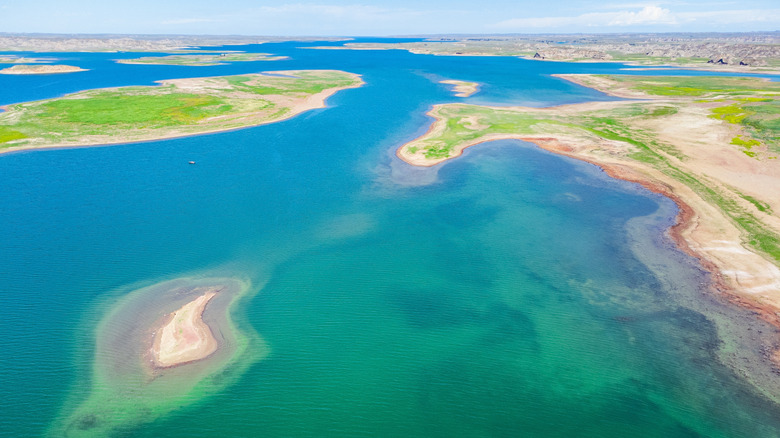 Blue, clear water with inlets and islands at Fort Peck Lake