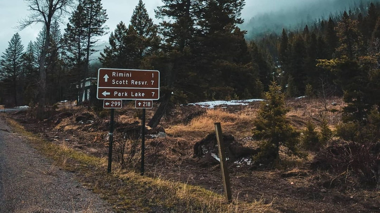 Image of a sign along Rimini Road leading to the almost-abandoned ghost town of Rimini, located in central west Montana, USA
