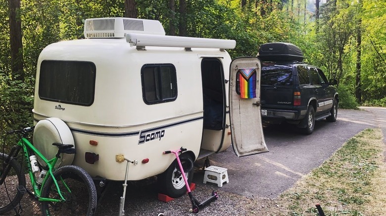 camping trailer behind vehicle parked in camping spot at Whitefish Lake State Park