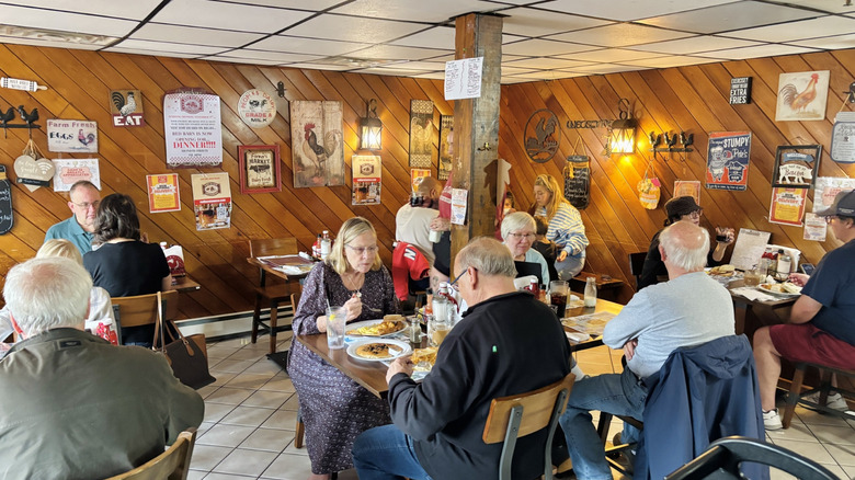 Diners at the Red Barn Restaurant, with old-fashioned signs adorning the walls
