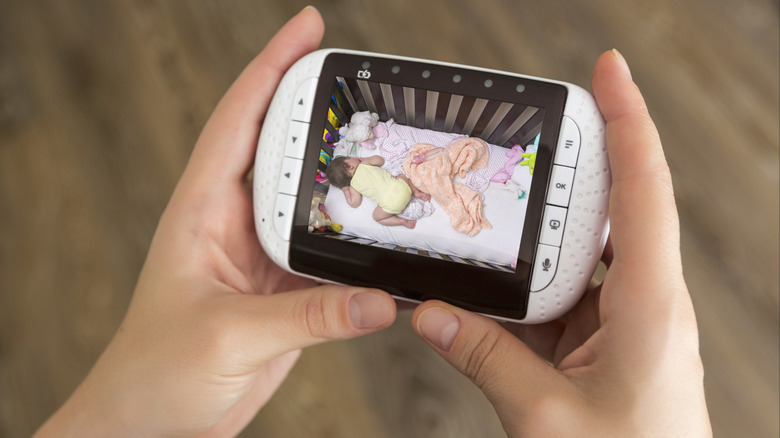 A person holding a baby monitor