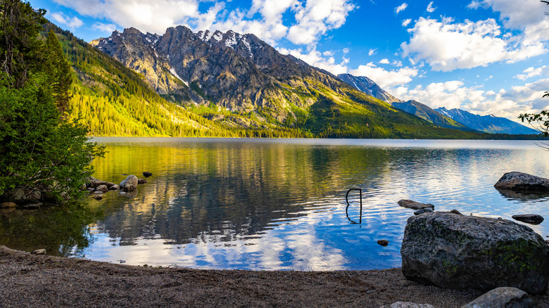 The majestic Teton mountains mirrored in the crystal clear waters of Jenny Lake