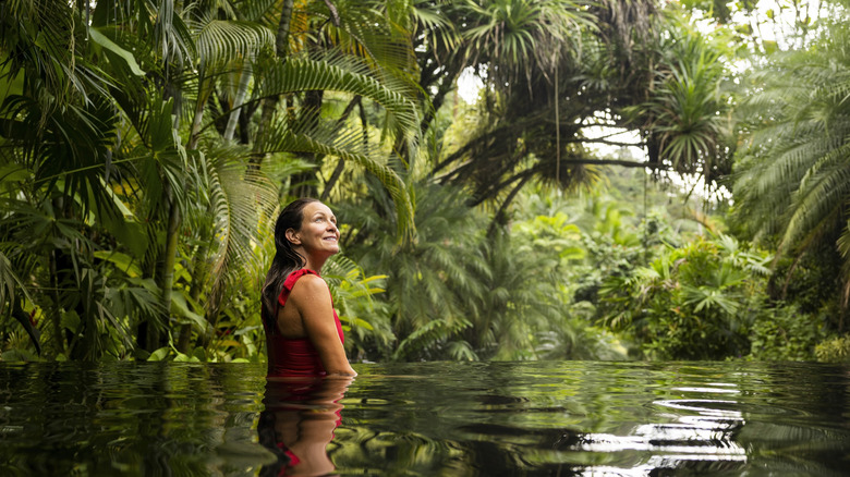 A woman in the water in a Costa Rican jungle.