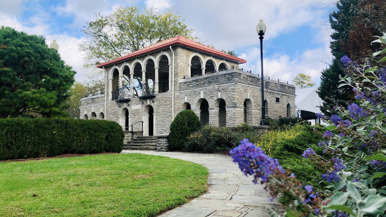 A stone building with a green lawn and shrubs at Alms Park, Ohio