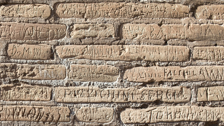 Wall of Colosseum with names scratched in