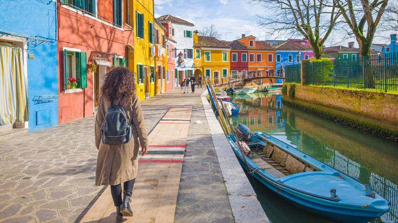 A woman walking around Burano, Venice