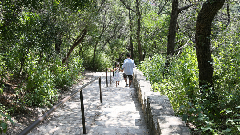 A man and a girl walking down stairs on Mount Bonnell in Austin, Texas
