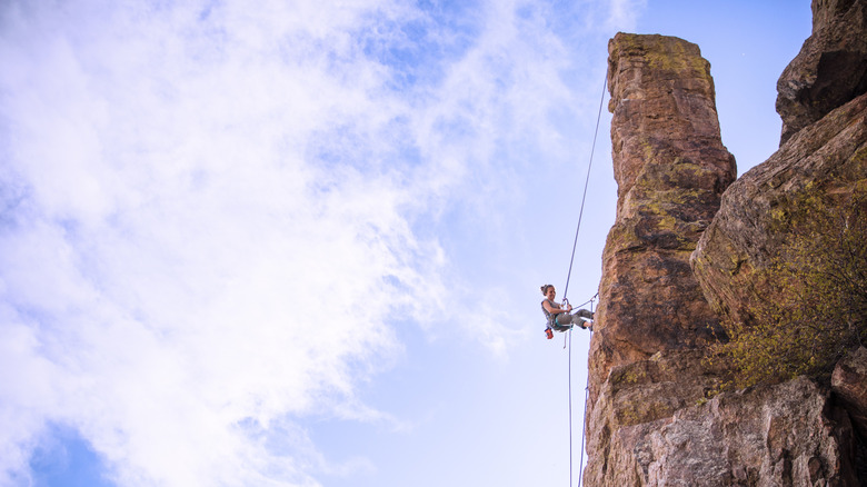 Climber descending a rock formation