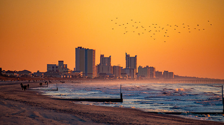 Myrtle Beach at sunrise with city buildings in the distance
