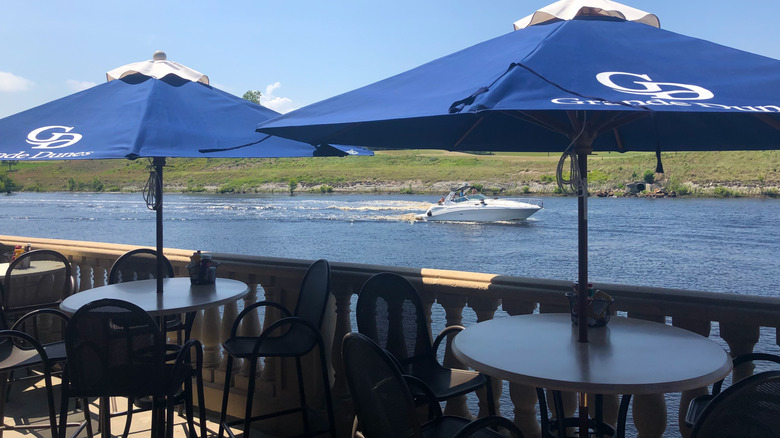 Restaurant at Grande Dunes overlooks boater on Intracoastal Waterway