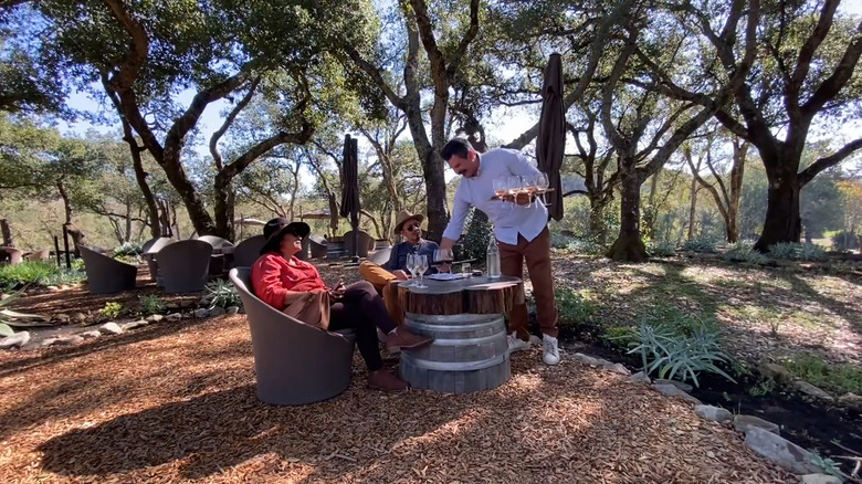 A couple is served at an outdoor wine tasting at Bartholomew Estate Winery