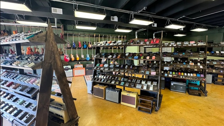 Interior of Eastside Music Supply, featuring shelves full of pedals, guitars, and amps