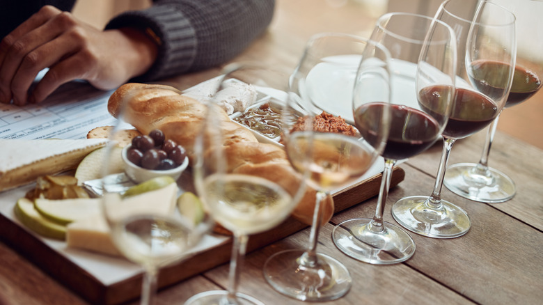 A wine tasting with a bread and cheeseboard.