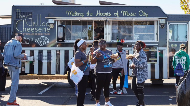 Patrons gather outside Grilled Cheeserie food truck in Nashville, Tennessee