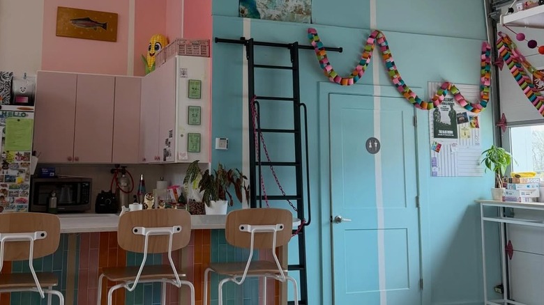 Interior of Matryoshka Coffee, Nashville, with blue and pink walls and stools at the counter