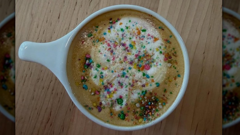 Overhead view of a latte from Matryoshka Coffee, Nashville, with sprinkles and foam