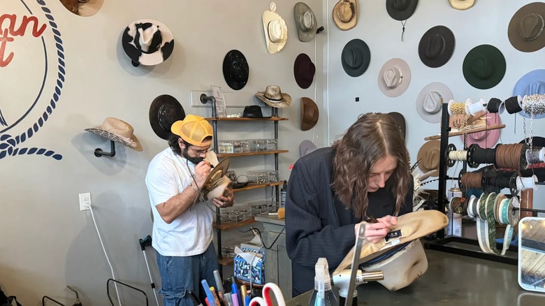 Staff members work on crafting custom cowboy hats at American Paint in The Nations, Nashville